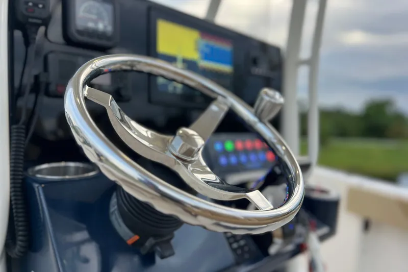 Slide: The Image of Steering wheel of 2017 Pursuit C 238 Center Console boat, with control panel. - 55