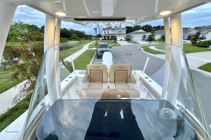Slide: The Image of 2017 Pursuit C 238 Center Console boat parked in a suburban neighborhood. - 38