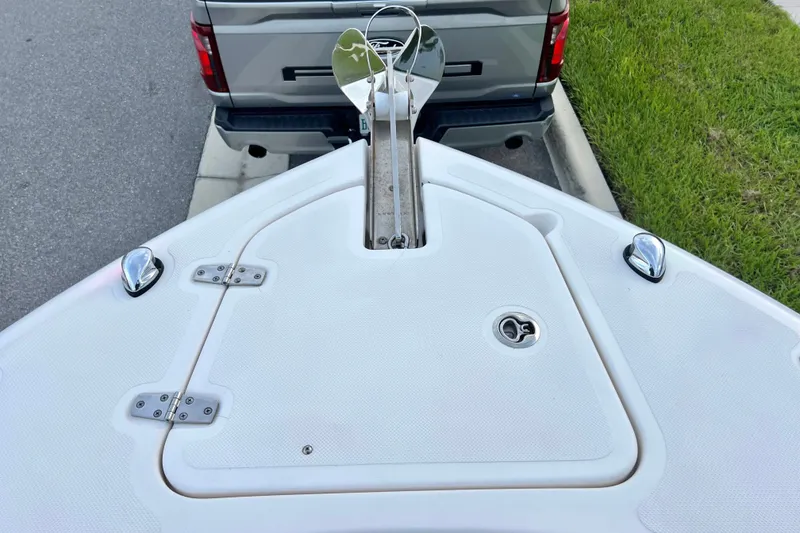 Slide: The Image of Bow of a 2017 Pursuit C 238 Center Console boat with anchor, parked near a truck. - 65