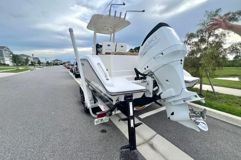 Slide: The Image of 2017 Pursuit C 238 Center Console boat with Suzuki outboard motor on a trailer. - 13