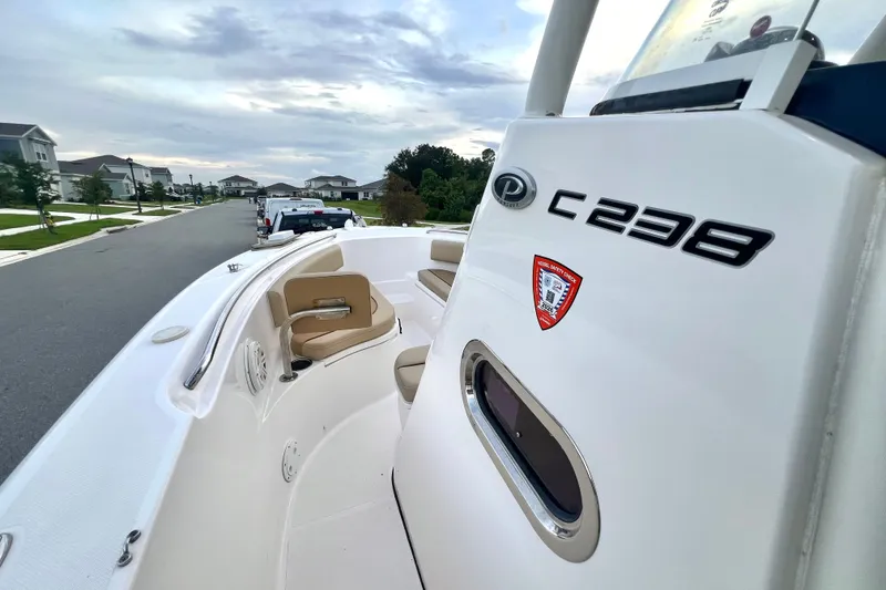 Slide: The Image of 2017 Pursuit C 238 Center Console boat parked on a suburban street. - 58