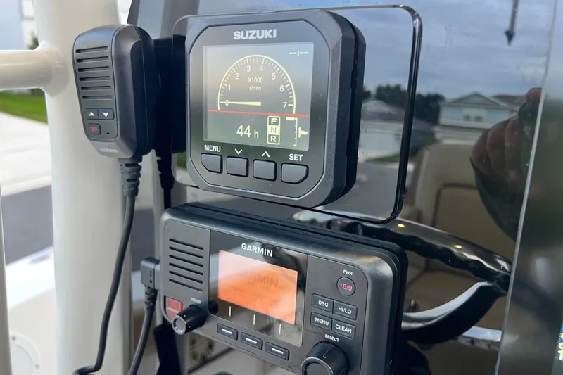 Slide: The Image of Close-up of Suzuki and Garmin marine electronics on a 2017 Pursuit C 238 Center Console. - 49