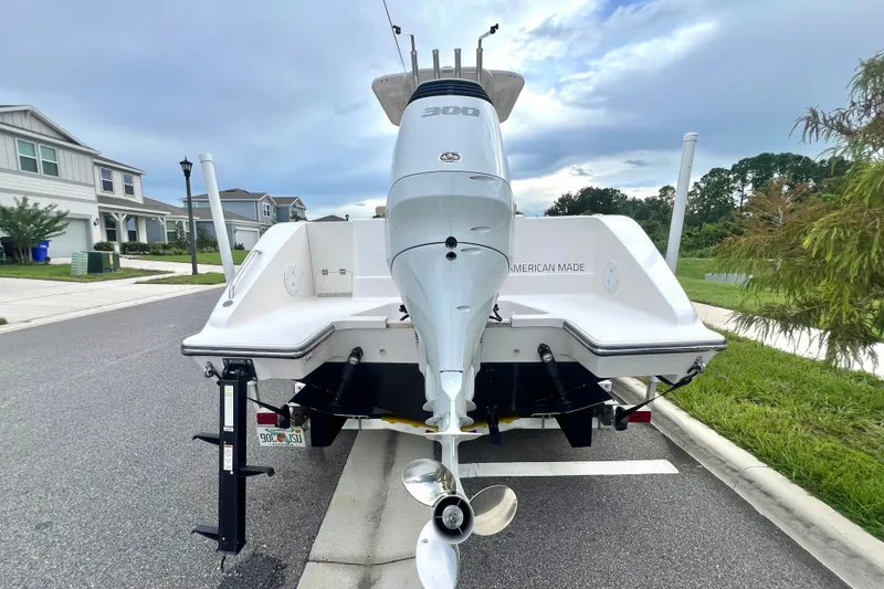 Slide: The Image of 2017 Pursuit C 238 Center Console boat with powerful outboard motor on a suburban street. - 5