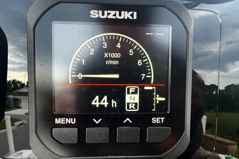 Slide: The Image of Suzuki engine display showing 44 hours on a 2017 Pursuit C 238 Center Console. - 45