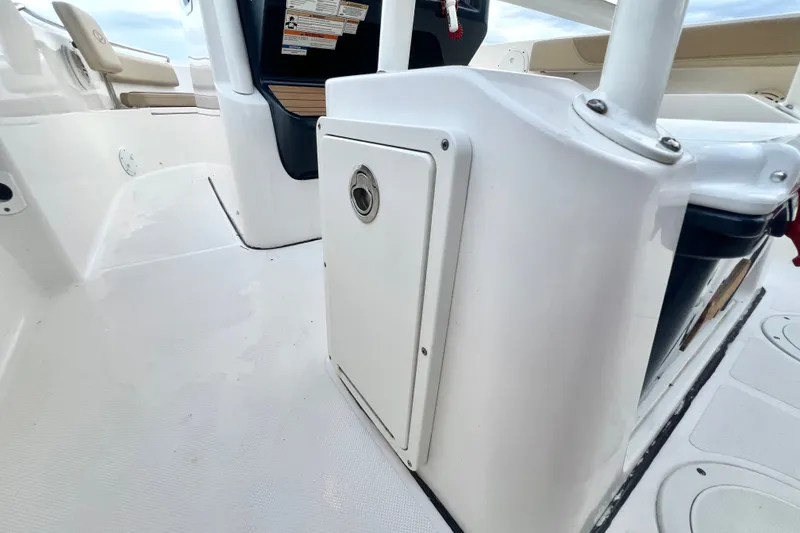 Slide: The Image of 2017 Pursuit C 238 Center Console interior, showcasing sleek white design and storage compartment. - 71