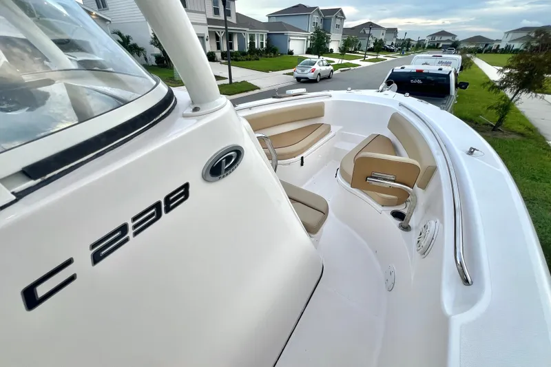 Slide: The Image of 2017 Pursuit C 238 Center Console boat parked in a suburban neighborhood. - 61
