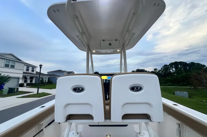 Slide: The Image of 2017 Pursuit C 238 Center Console boat with dual seats, parked in a suburban neighborhood. - 73