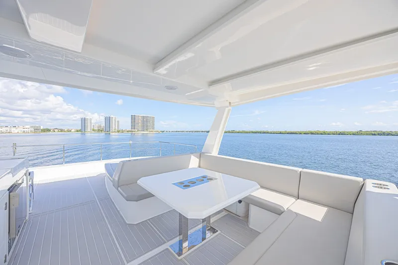 Slide: The Image of Luxurious deck view on 2025 Leopard 53 Powercat yacht, overlooking serene waterfront and skyline. - 26