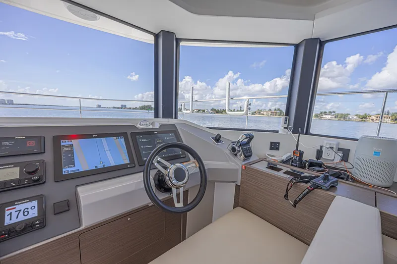 Slide: The Image of Interior helm of 2025 Leopard 53 Powercat with navigation equipment and ocean view. - 41