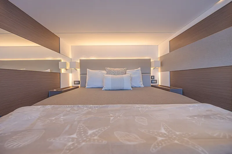 Slide: The Image of Luxurious bedroom interior on 2025 Leopard 53 Powercat yacht, featuring elegant bedding and ambient lighting. - 52