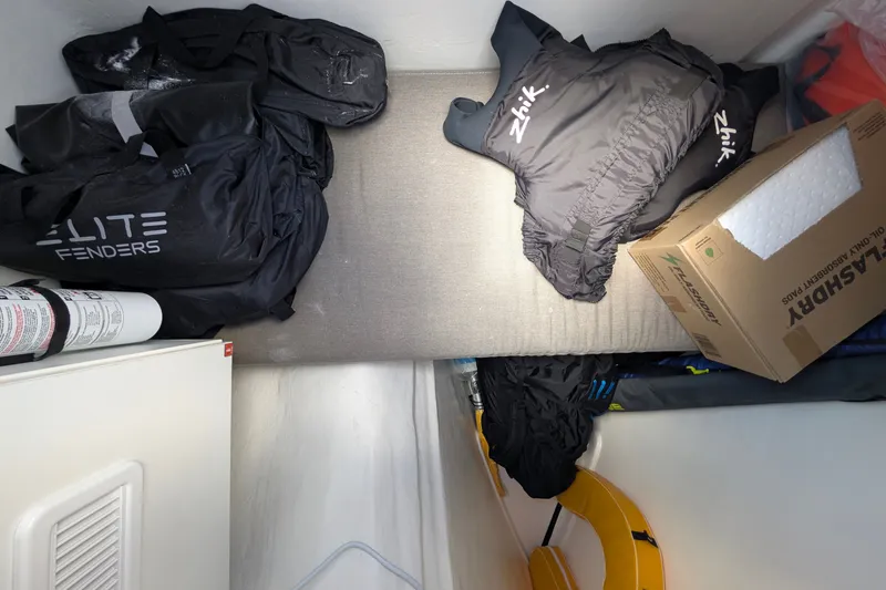 Slide: The Image of Storage area on a 2025 Leopard 53 Powercat with gear bags and safety equipment. - 65