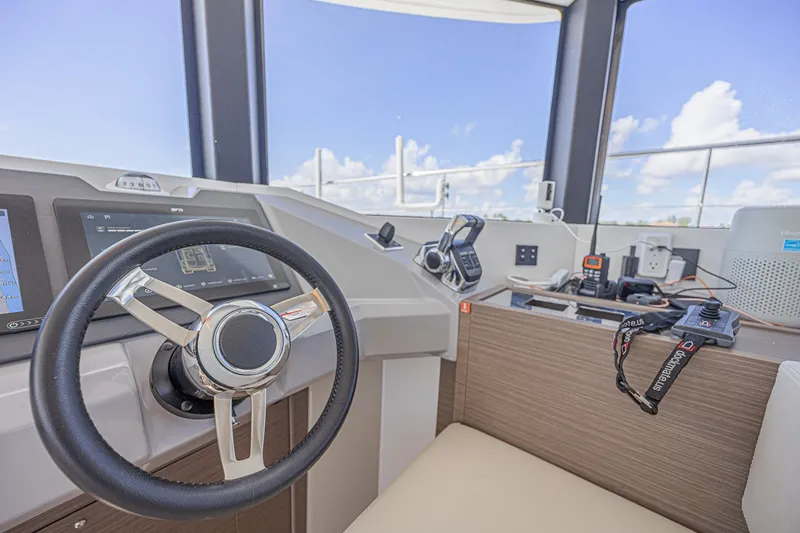 Slide: The Image of Helm of 2025 Leopard 53 Powercat with steering wheel and navigation controls. - 42