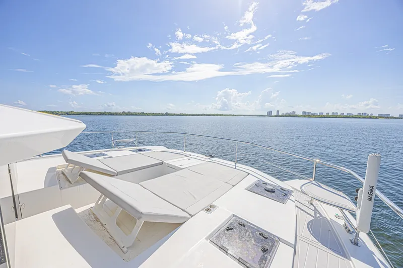 Slide: The Image of Luxurious 2025 Leopard 53 Powercat yacht deck with sun loungers, overlooking serene ocean view. - 15