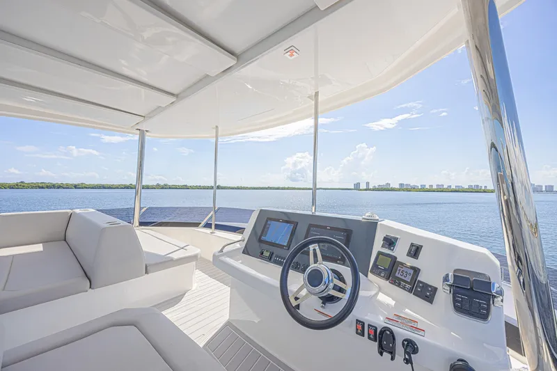 Slide: The Image of 2025 Leopard 53 Powercat helm with panoramic water view and modern navigation controls. - 32