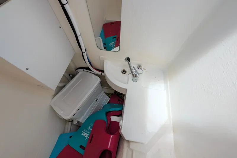 Slide: The Image of Compact bathroom space on a 2025 Leopard 53 Powercat yacht, featuring a small sink and storage. - 69