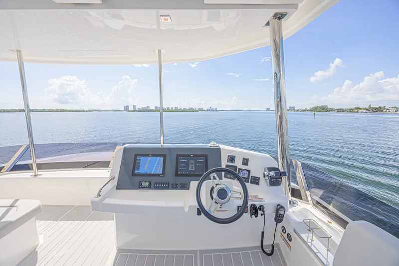 Slide: The Image of Helm of 2025 Leopard 53 Powercat with navigation screens, overlooking calm waters. - 30