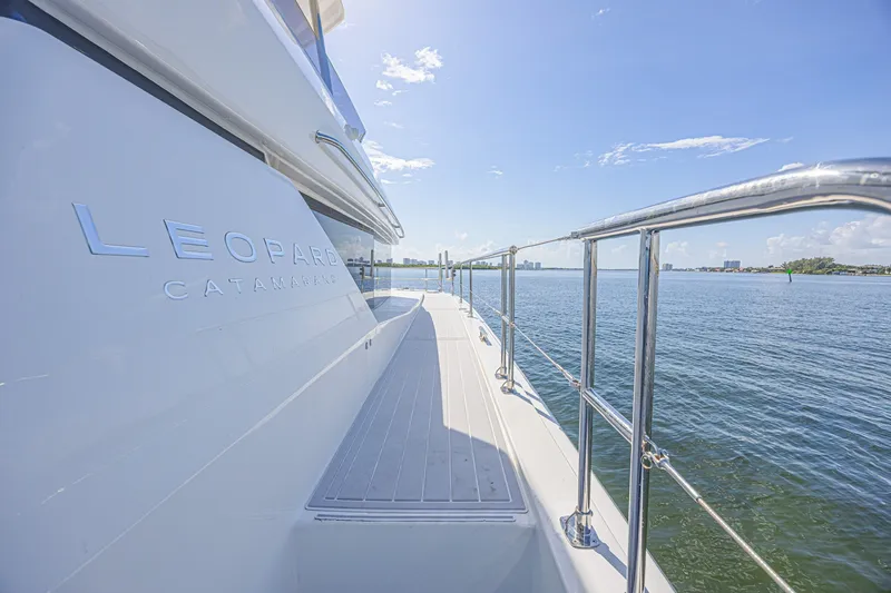 Slide: The Image of 2025 Leopard 53 Powercat yacht on serene water, showcasing sleek design and luxury. - 14