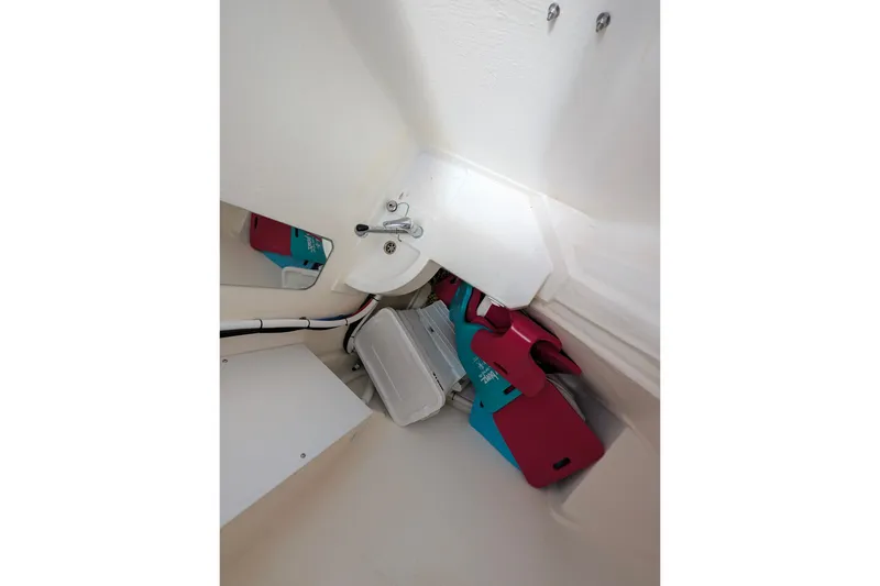Slide: The Image of Interior view of 2025 Leopard 53 Powercat, featuring compact storage and plumbing fixtures. - 68
