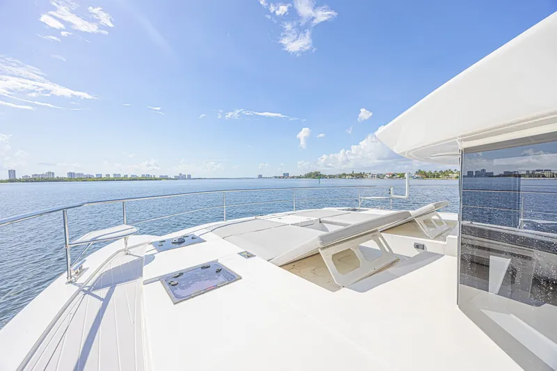 Slide: The Image of Luxurious 2025 Leopard 53 Powercat yacht deck with ocean view under clear blue sky. - 17