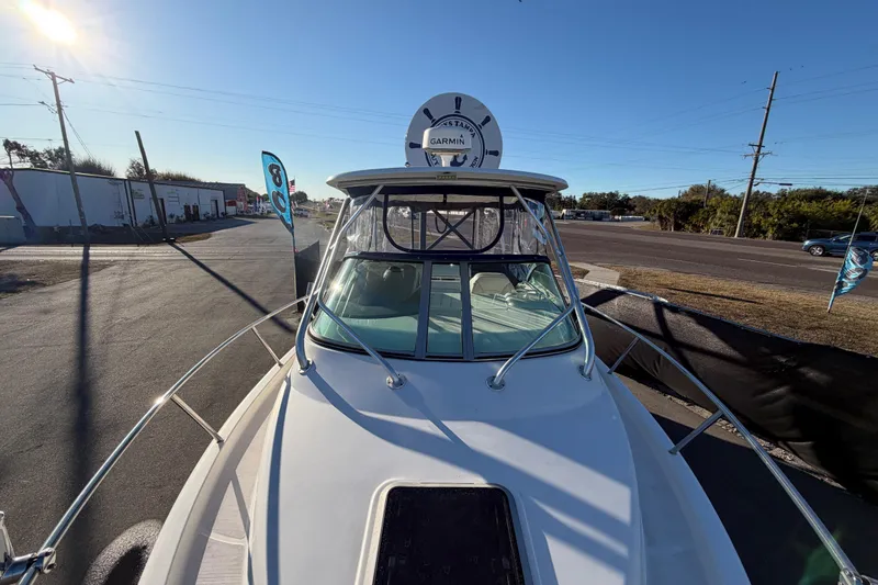Slide: The Image of 2017 Robalo R265 Walkaround boat with Garmin radar, parked on a sunny day. - 52