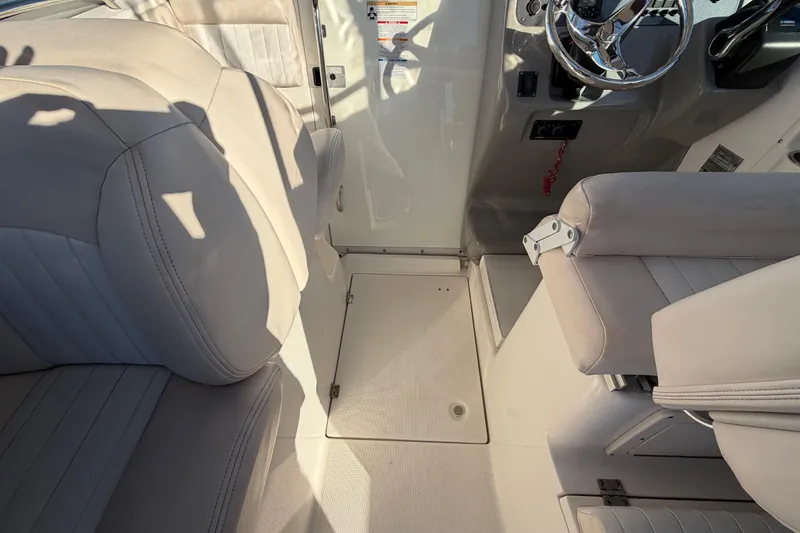 Slide: The Image of 2017 Robalo R265 Walkaround boat interior with beige seating and steering wheel. - 25