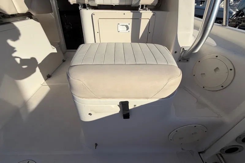 Slide: The Image of 2017 Robalo R265 Walkaround boat interior with cushioned seating and storage. - 21