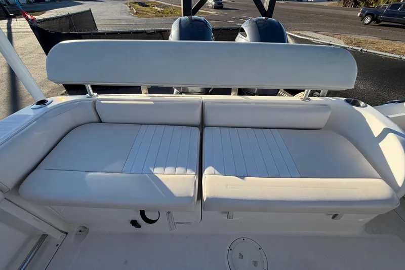 Slide: The Image of 2017 Robalo R265 Walkaround boat with white cushioned seating and dual engines. - 58