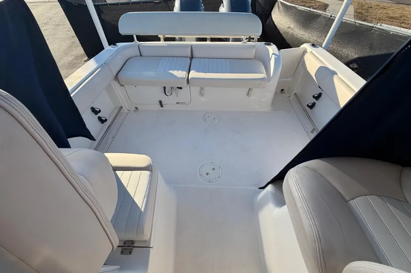 Slide: The Image of 2017 Robalo R265 Walkaround boat interior with cushioned seating and spacious deck area. - 56