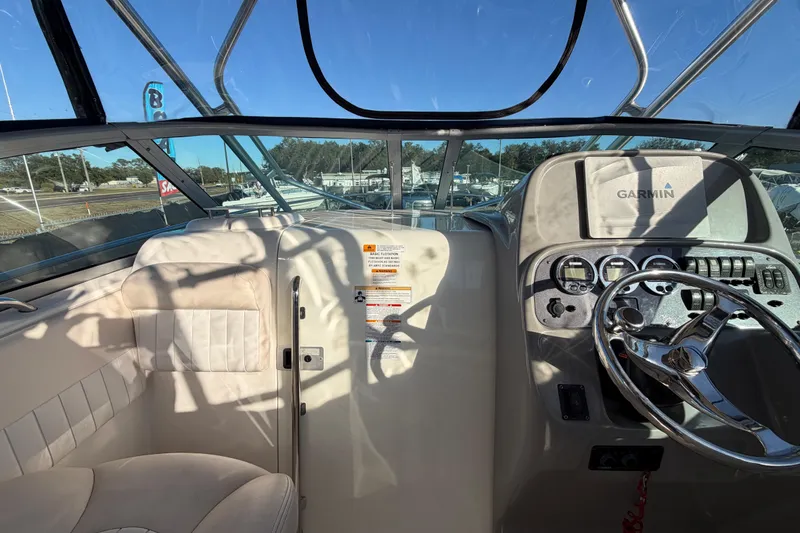 Slide: The Image of 2017 Robalo R265 Walkaround boat interior with steering wheel and Garmin navigation system. - 26
