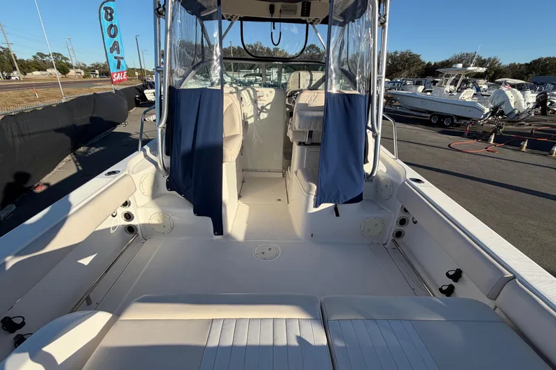 Slide: The Image of 2017 Robalo R265 Walkaround boat interior at a sale event, showcasing seating and helm area. - 17