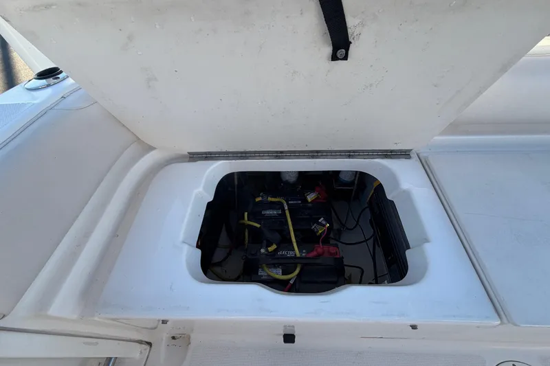 Slide: The Image of 2017 Robalo R265 Walkaround boat battery compartment with open hatch. - 60