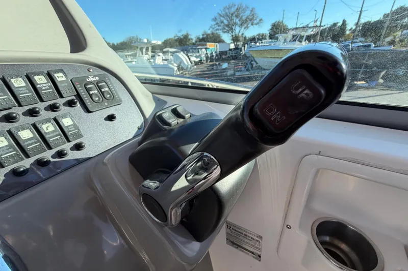 Slide: The Image of 2017 Robalo R265 Walkaround boat control panel with throttle lever and switches. - 34