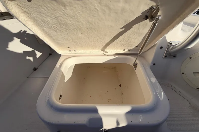Slide: The Image of Open storage compartment on 2017 Robalo R265 Walkaround boat, showing interior details. - 22