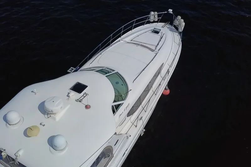 Slide: The Image of Aerial view of 2003 Sea Ray 480 Motor Yacht on dark water. - 216