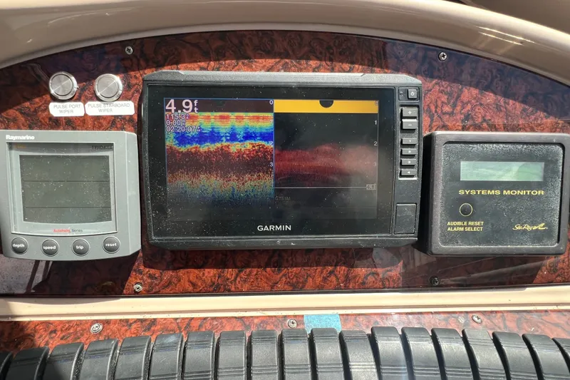 Slide: The Image of Dashboard of a 2003 Sea Ray 480 Motor Yacht with Garmin and Raymarine displays. - 90