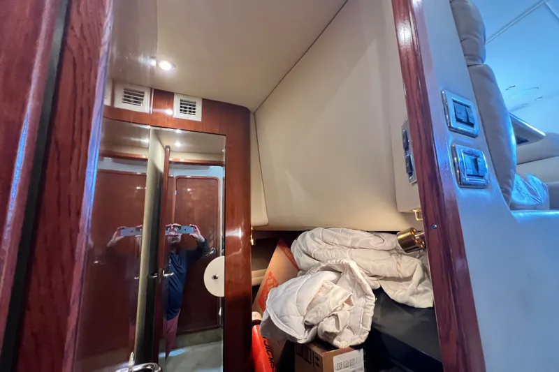 Slide: The Image of Interior of 2003 Sea Ray 480 Motor Yacht with wood paneling and storage area. - 120