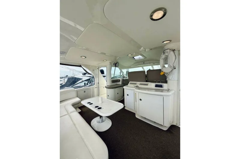 Slide: The Image of Interior of 2003 Sea Ray 480 Motor Yacht with white seating and modern amenities. - 16
