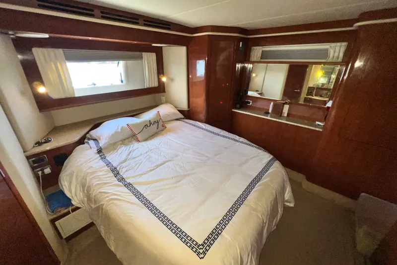 Slide: The Image of Luxurious bedroom interior of 2003 Sea Ray 480 Motor Yacht with elegant wood finishes. - 143