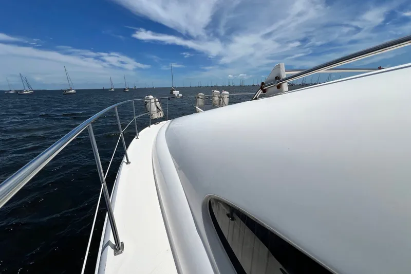 Slide: The Image of 2003 Sea Ray 480 Motor Yacht on open water under a clear blue sky. - 59