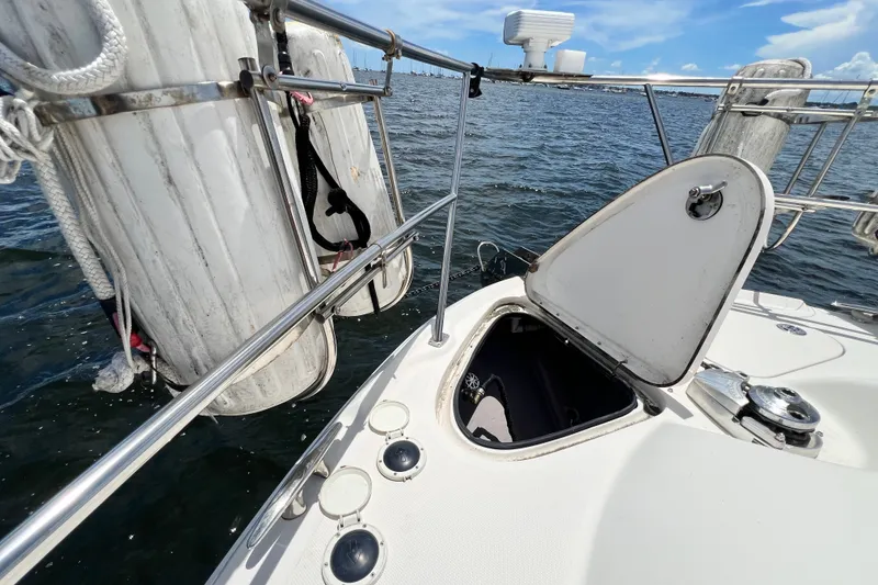 Slide: The Image of 2003 Sea Ray 480 Motor Yacht deck with open hatch and fenders, on calm water. - 63