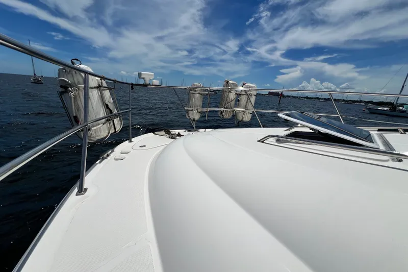 Slide: The Image of 2003 Sea Ray 480 Motor Yacht deck view with ocean and sky backdrop. - 61