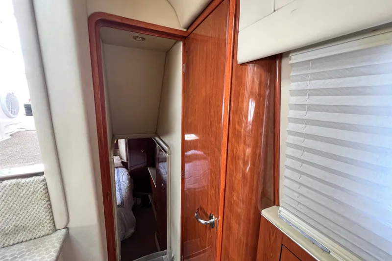 Slide: The Image of Interior view of 2003 Sea Ray 480 Motor Yacht with wooden door and cozy cabin. - 146