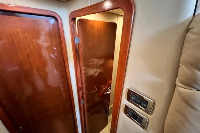 Slide: The Image of Interior view of 2003 Sea Ray 480 Motor Yacht with wooden doors and control panels. - 119