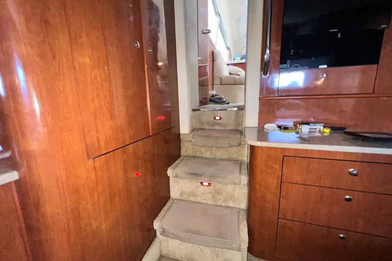 Slide: The Image of Interior of 2003 Sea Ray 480 Motor Yacht with wooden cabinetry and carpeted stairs. - 144