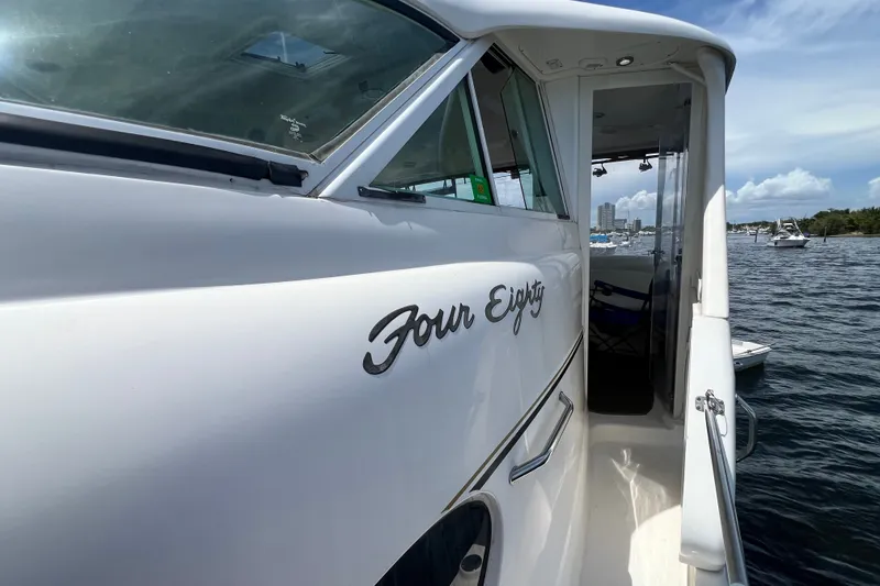 Slide: The Image of 2003 Sea Ray 480 Motor Yacht on water, side view with "Four Eighty" text. - 78