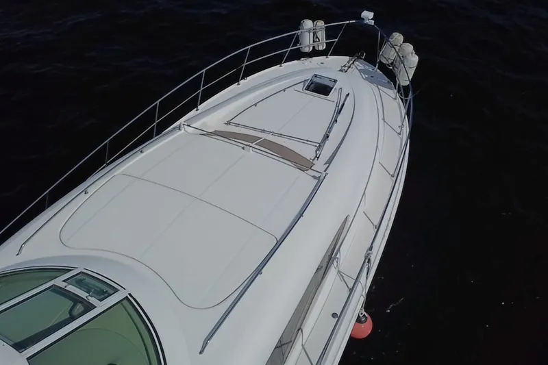 Slide: The Image of 2003 Sea Ray 480 Motor Yacht on calm waters, aerial view of sleek deck design. - 218