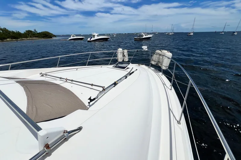 Slide: The Image of 2003 Sea Ray 480 Motor Yacht on calm waters with other boats nearby. - 69