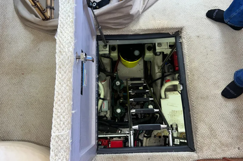 Slide: The Image of Engine compartment of a 2003 Sea Ray 480 Motor Yacht, accessed through a carpeted hatch. - 51
