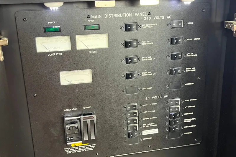 Slide: The Image of Main distribution panel of 2003 Sea Ray 480 Motor Yacht, showing power controls and switches. - 151