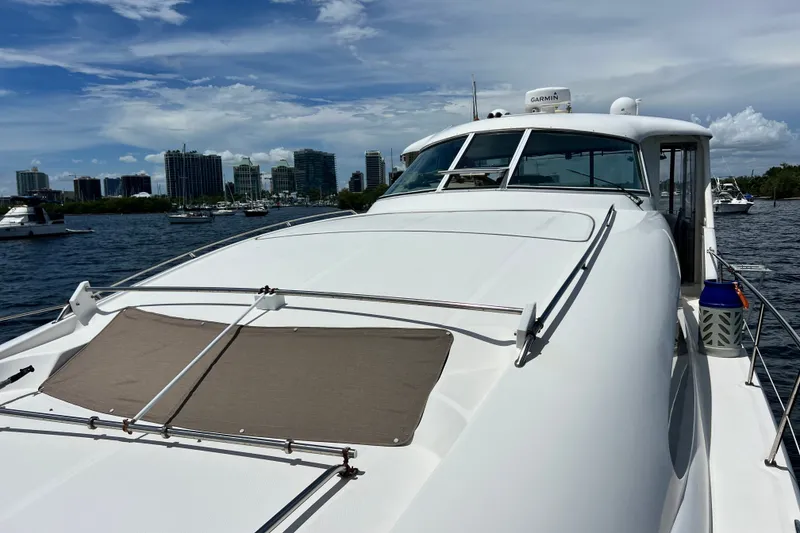 Slide: The Image of 2003 Sea Ray 480 Motor Yacht on water with city skyline in background. - 76
